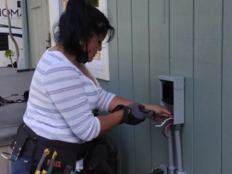 Licensed electrician wiring an exterior subpanel in Port Aransas